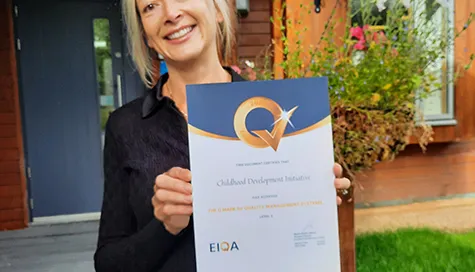 Tara Scott holds the EIQA award CDI achieved