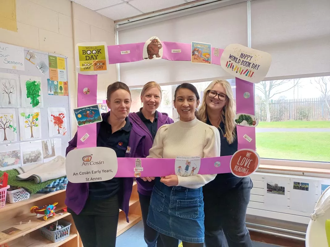 Four women in classroom with a cut out promoting world book day