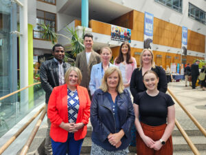 CDI team standing on steps at the ABC 10 yr anniversary event,